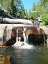 Sierra Swimming hole trip 20040730; Whiskers Swimming hole; Craig cooling off under a little cascade;